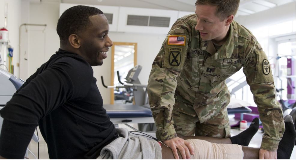 a U.S. service member receives physical therapy rehab from another U.S. service member medical practitioner