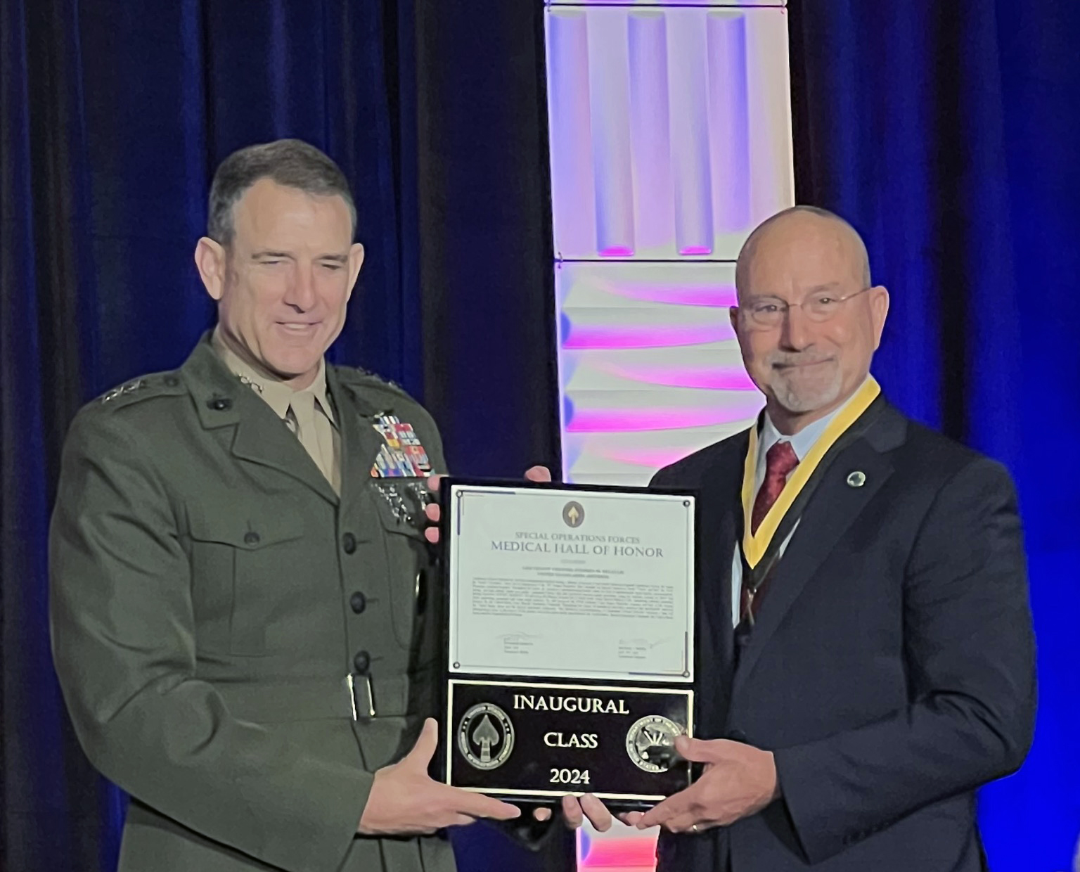 Lieutenant General Francis L. Donovan, Vice Commander, USSOCOM (left) presents Special Operations Forces Medical Hall of Honor plaque to LTC (Ret.) Stephen DeLellis, PA-C